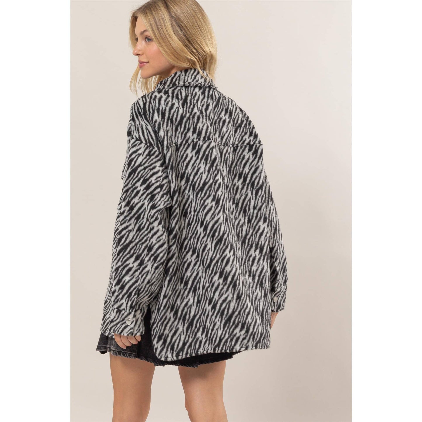 Woman wearing a zebra print jacket.