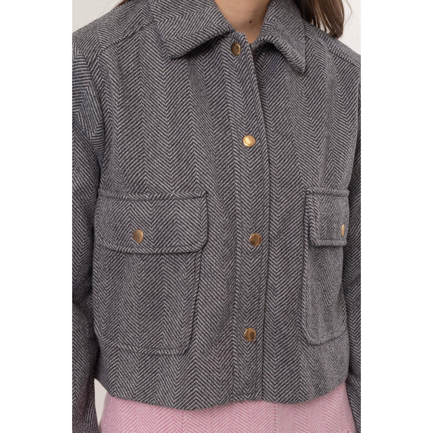 Gray herringbone jacket with button details.