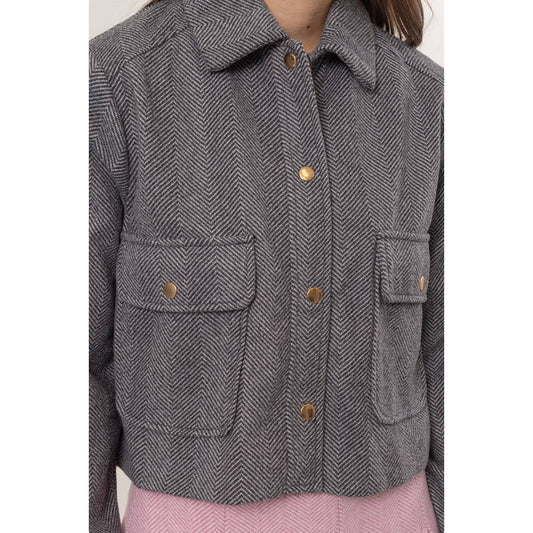Gray herringbone jacket with button details. 
