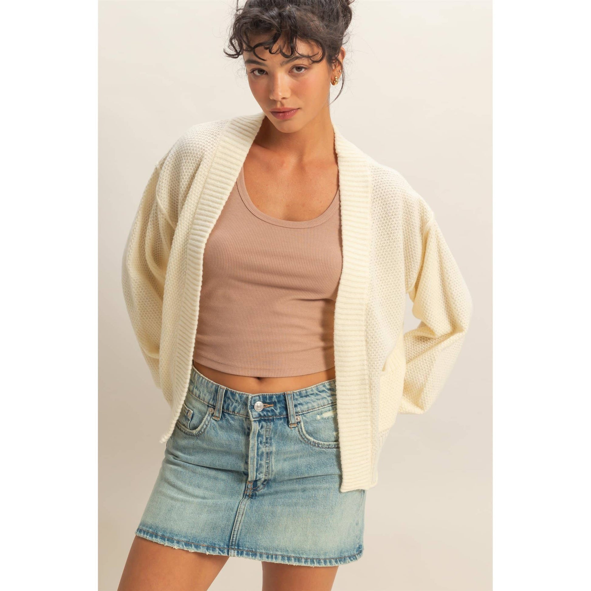 Woman wearing a cream oversized textured knit cardigan